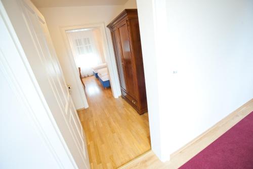 an empty hallway with a room with a door at Stadthotel zur goldenen Krone in Weiz