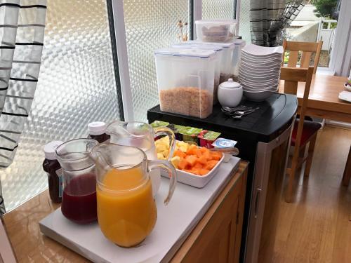 a kitchen counter with a bunch of juice and fruits at The Langtons in Eastbourne