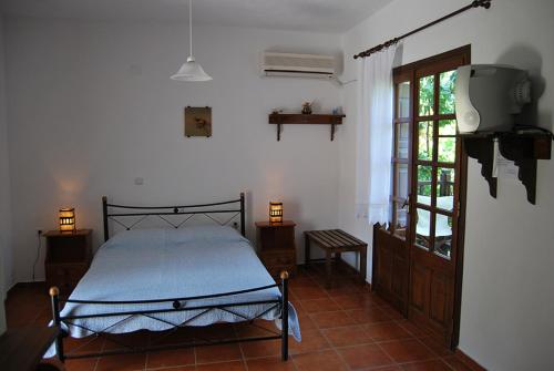 a bedroom with a bed in a room with a window at Villa Katerina in Platanias