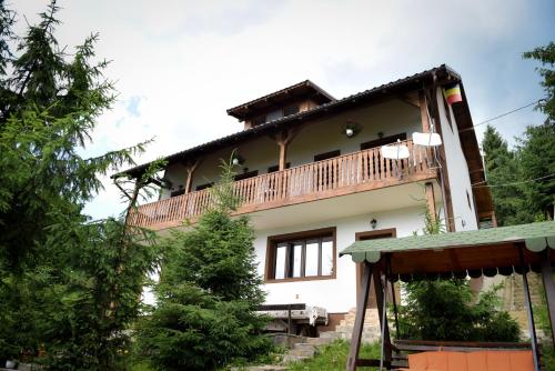 a house with a balcony on top of it at Casa Edy in Colibiţa