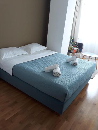 a bedroom with a bed with towels on it at Modern Living Apartments in Skopje