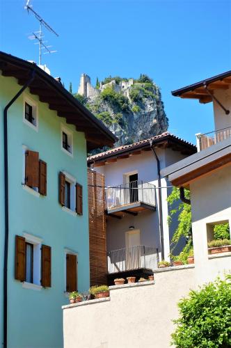 a building with balconies and a mountain in the background at Aquila in Arco