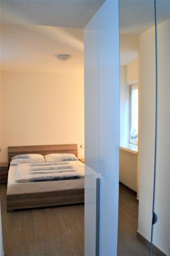 a bedroom with a bed and a glass wall at Aquila in Arco