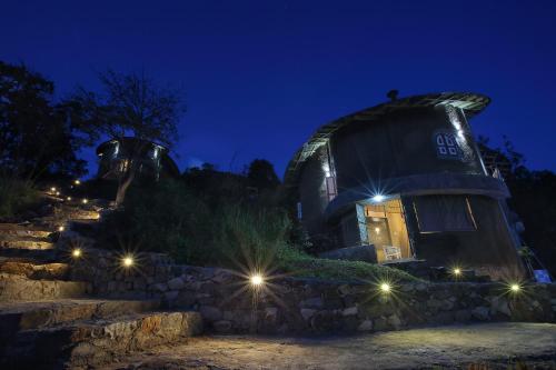 an observatory at night with lights on a wall at Villa Verde Ella in Ella