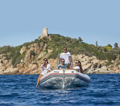 a group of people on a boat in the water at Hotel Club Saraceno - Bovis Hotels in Àrbatax