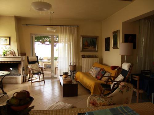 a living room with a couch and a fireplace at Villa Emma in Agia Fotia