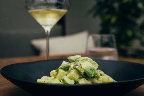 a blue plate of food and a glass of wine at ICON Embassy in Madrid