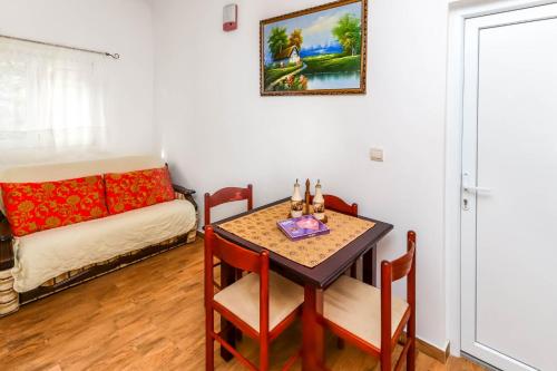 a living room with a table and a couch at Apartments Zeko in Donji Morinj