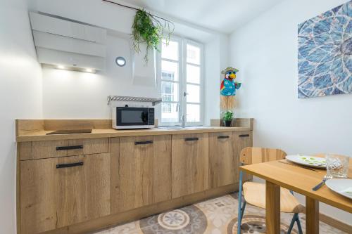 a kitchen with a microwave on top of a counter at Valbonne Flat in Valbonne