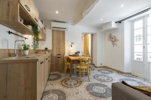 a kitchen with a table and a dining room at Valbonne Flat in Valbonne