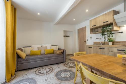 a living room with a couch and a table at Valbonne Flat in Valbonne