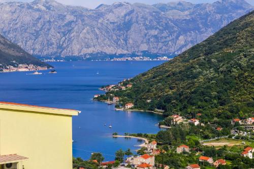 a view of a lake with mountains in the background at Apartments Zeko in Donji Morinj