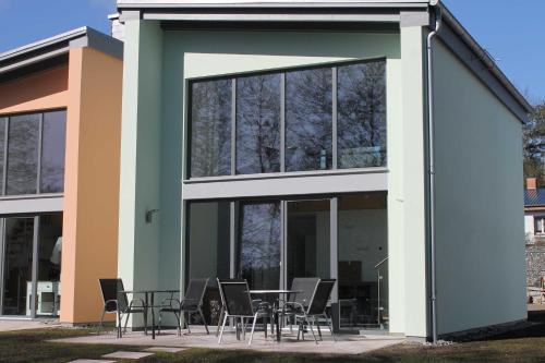 a group of chairs and tables outside of a building at Ferienpark Kunterbunt in Krakow am See