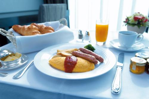 a table with a plate of food with sausage and bread at Hotel New Otani Tokyo Garden Tower in Tokyo