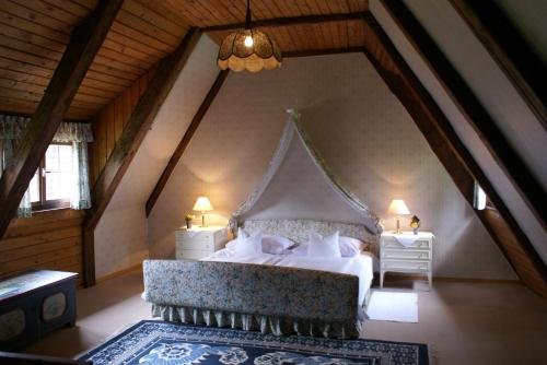 a bedroom with a large bed in a attic at Schloss Egg in Bernried
