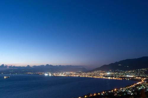 a view of a city and the water at night at Kalamata Art Rooms in Kalamata
