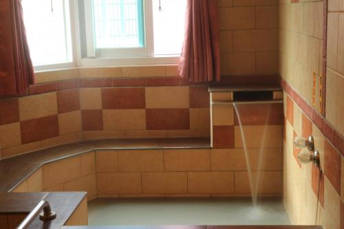 a bathroom with a bath tub with a window at Li Tang in Baihe