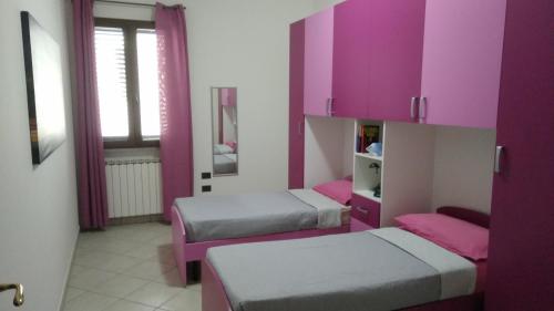 Postel nebo postele na pokoji v ubytování Casa Vacanze Leo