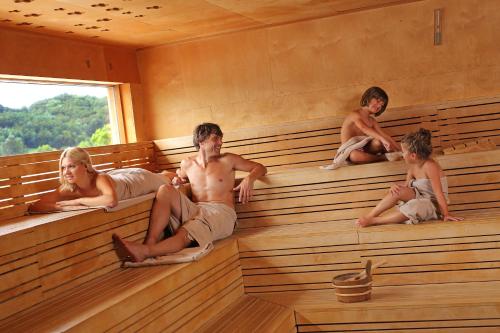 a group of people sitting in a sauna at Terme Tuhelj Hotel Well in Tuheljske Toplice