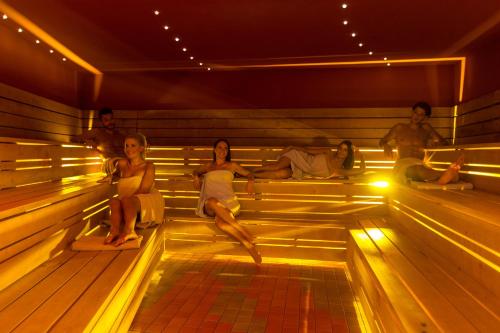 a group of people sitting in a sauna at Terme Tuhelj Hotel Well in Tuheljske Toplice
