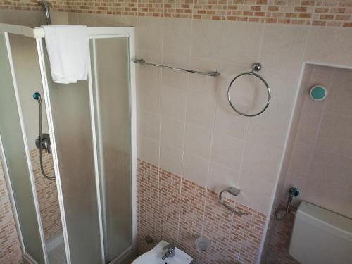 a bathroom with a shower and a toilet at Garden Inn in Capua