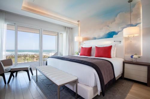 a bedroom with a large bed and a large window at The View Bouznika in Bouznika