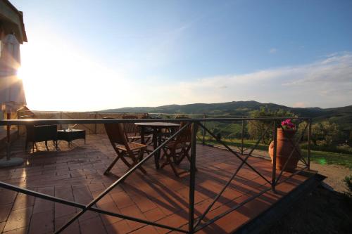 a balcony of a house with a table and chairs at Tenuta il Poggetto in Radda in Chianti