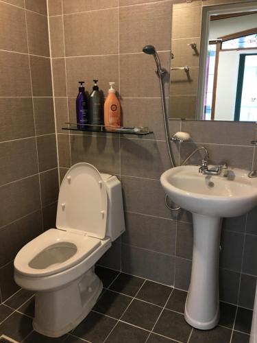 a bathroom with a toilet and a sink at Take 1 Guesthouse Hongdae in Seoul