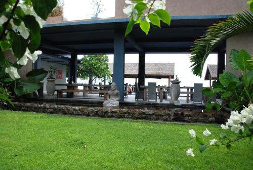 a statue sitting under a pavilion in a park at Cafe Alberto B and B in Senggigi 