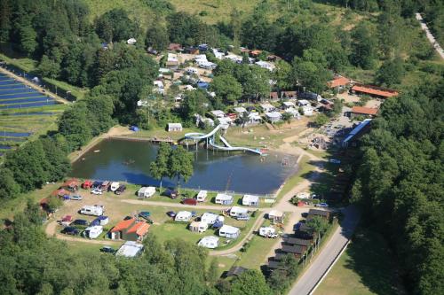 an aerial view of a camping area with a lake and a park at Randbøldal Camping & Cabins in Randbøl