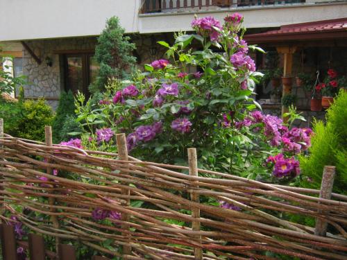 a wooden fence in front of some flowers at Risto's Guest House in Ohrid