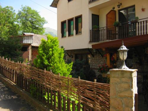 a fence in front of a house with a building at Risto's Guest House in Ohrid