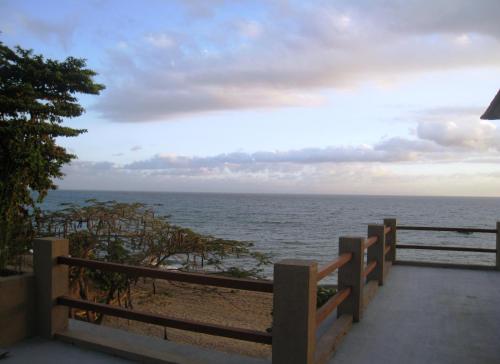 a view of the ocean from a wooden fence at Cafe Alberto B and B in Senggigi 