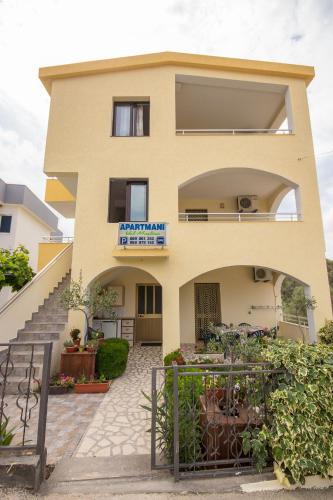 a house with a staircase in front of it at Apartments Val Maslina in Utjeha