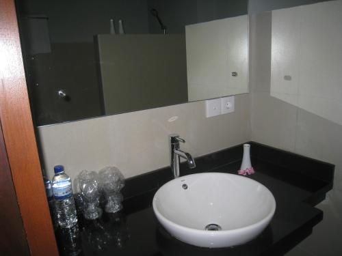 a bathroom with a sink and a mirror at Cafe Alberto B and B in Senggigi 
