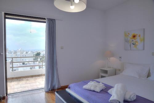 A bed or beds in a room at Athens Glyfada Riviera Apartment