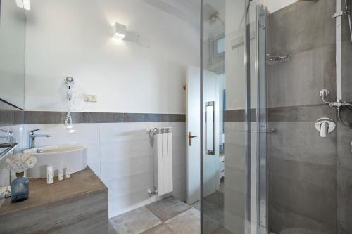 a bathroom with a shower, sink, and toilet at Hotel Il Cefalo in Castellabate