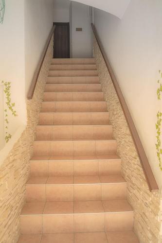 a staircase with wooden treads in a building at Hotel des Etrangers in Bonifacio