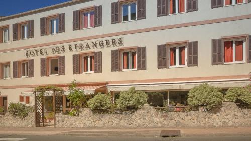 a building with a sign that reads hotel des stranger at Hotel des Etrangers in Bonifacio