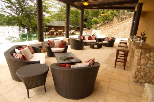 a patio with couches and chairs on a patio at Las Lagunas Boutique Hotel in Flores