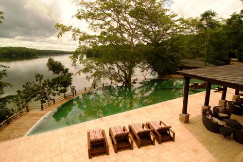 a pool with chairs and a view of a lake at Las Lagunas Boutique Hotel in Flores
