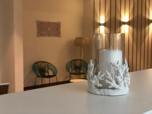 a candle in a glass vase sitting on a table at Hotel Planas in Salou