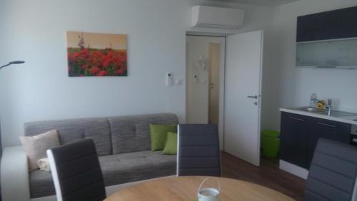 a living room with a couch and a table at Ferienhaus Szapary II in Eisenberg an der Pinka