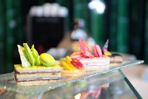 a group of desserts on a glass display case at Novotel Jazan in Jazan