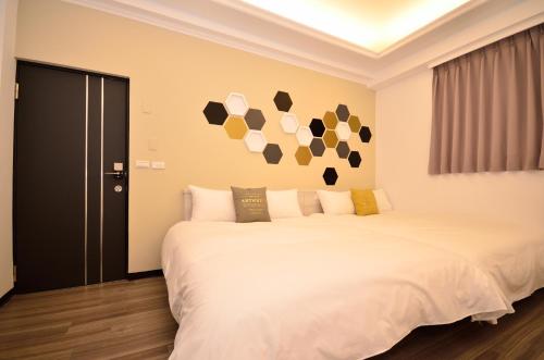 a bedroom with a large white bed in a room at Lè mù in Taichung