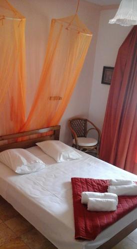 a bedroom with a bed with two towels on it at MARGARITAS' ROOMS in Agios Gordios