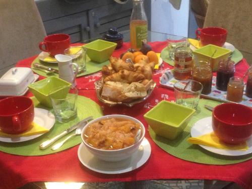 a table with a red table cloth with food on it at Casa Mia in Néfiach