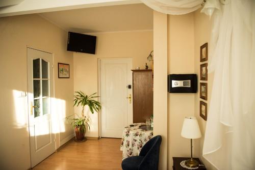 a hallway with a door and a table and a lamp at Lodownia in Szydłowiec
