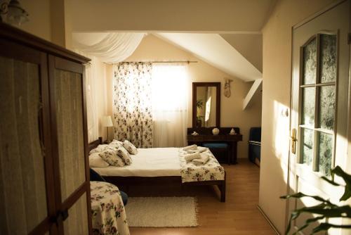a small bedroom with two beds and a window at Lodownia in Szydłowiec