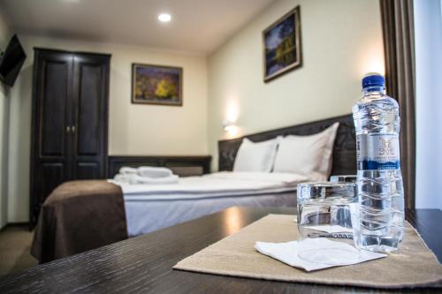 a bottle of water sitting on a table in a hotel room at Синевирський Перевал in Synevyr